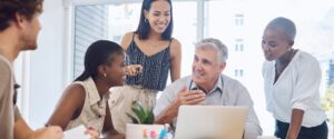 Older adult with younger adults in work environment
