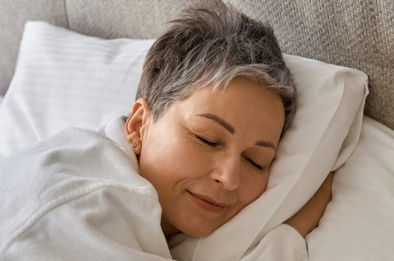 Woman sleeping comfortably in bed
